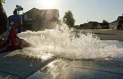 City employee flushing a fire hydrant